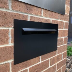 black letterboxes on outdoor wal